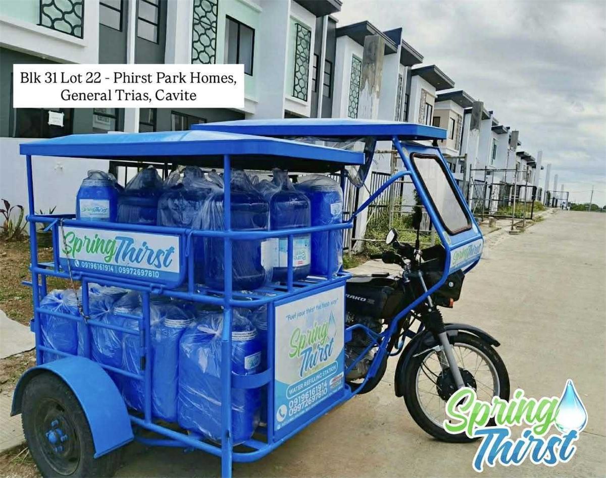 Spring Thirst delivery tricycle loaded with water at Phirst Park Homes, General Trias